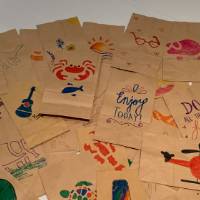 Completed lunch bags decorated by CECI faculty and staff members pile #8